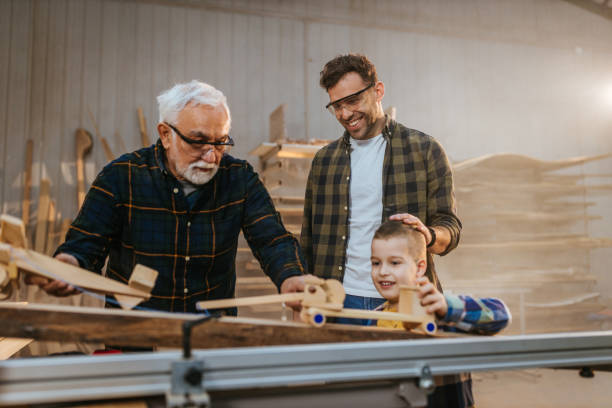 istock Father, son and grandfather in carpenter workshop 1313354896