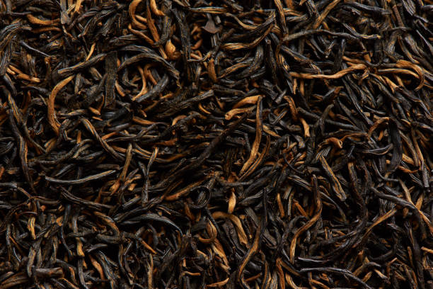 istock Texture of dry black tea leaves as a background. 1313357679