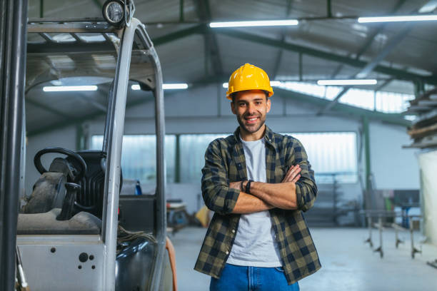istock Young adult worker standing beside forklift 1313357734
