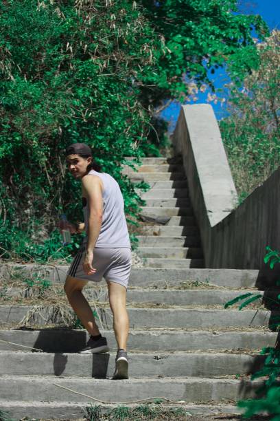 istock A young man does exercises in a natural park 1313357899