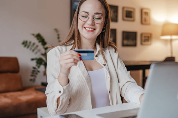 istock Young woman is using laptop at home and shopping online 1313358721