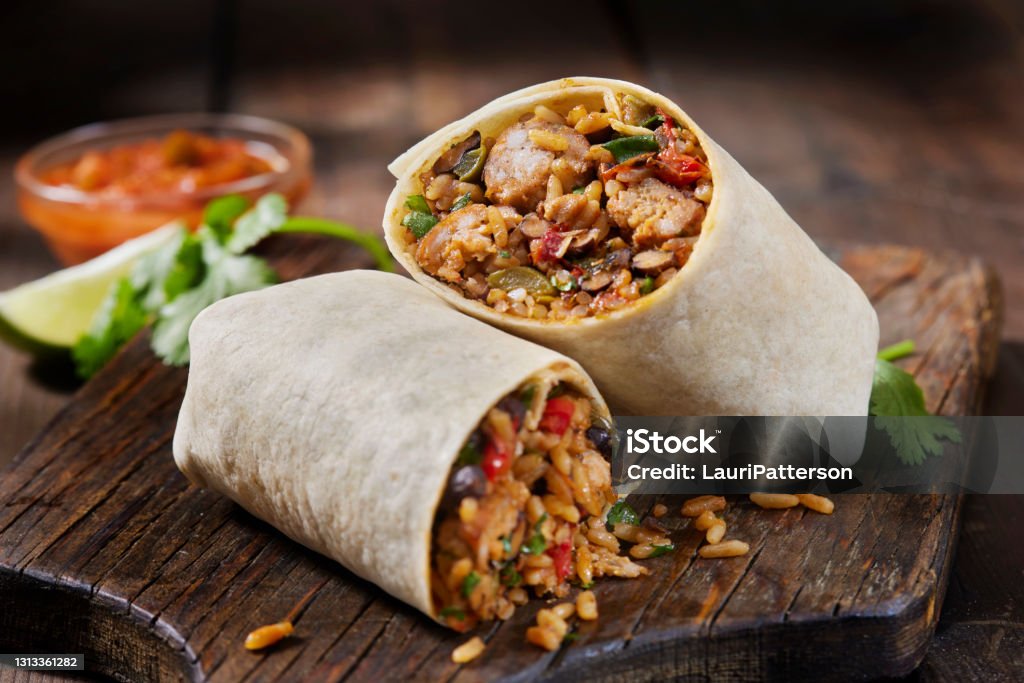 Mexican Rice and Chorizo Sausage Wrap Mexican Rice and Chorizo Sausage Wrap with Black Beans, Roast Peppers and Fresh Cilantro Burrito Stock Photo