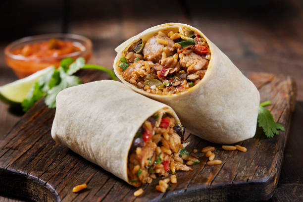 Mexican Rice and Chorizo Sausage Wrap Mexican Rice and Chorizo Sausage Wrap with Black Beans, Roast Peppers and Fresh Cilantro burrito photos stock pictures, royalty-free photos & images