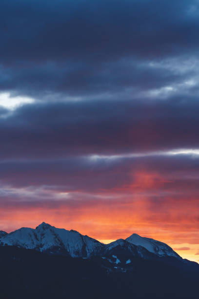 istock Alpine mountains with snow tops at sunset with dramatic red colored stormy cloudscape in Tirol, Austria 1313361600