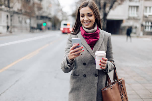istock Young woman walking after shopping and using phone 1313362129