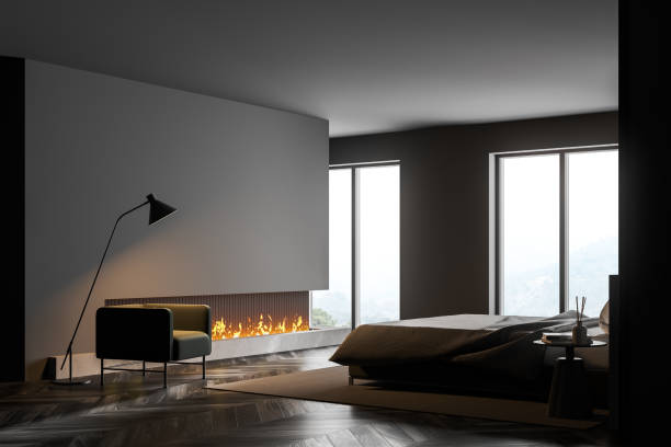istock Grey bedroom interior with fireplace, armchair and window, copy space 1313367390
