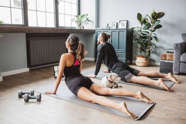 istock Couple practicing yoga at home 1313368365