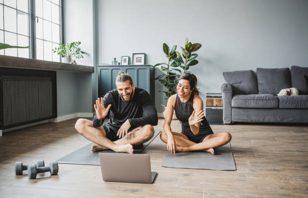 istock Couple practicing yoga at home 1313368430