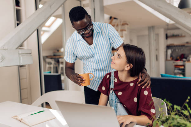 istock African American young man bringing coffee to his girlfriend while studying 1313368464