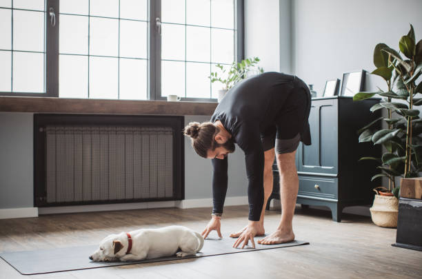 istock Young men at home practicing yoga 1313368474
