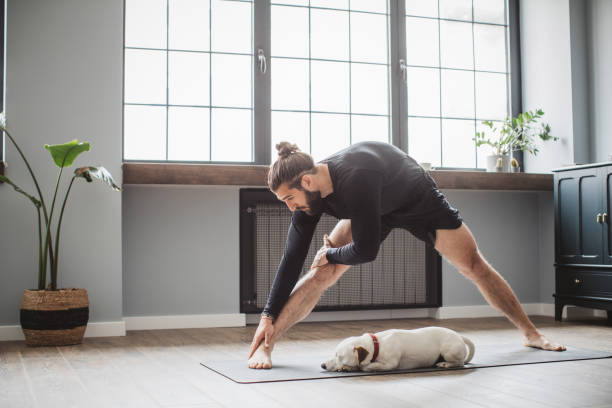 istock Young men at home practicing yoga 1313368484