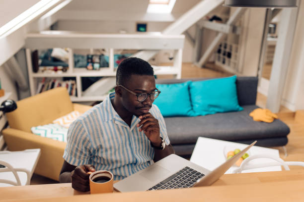 istock Happy African American student preparing the exam at home 1313368491