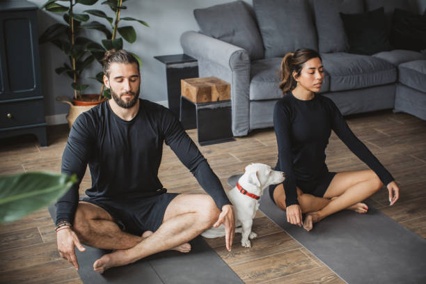 istock Couple practicing yoga at home 1313368547