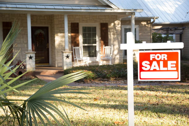 Home for sale with real estate sign.  Front Yard. stock photo