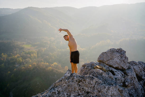 istock Young man stretching on the mountain 1313372053
