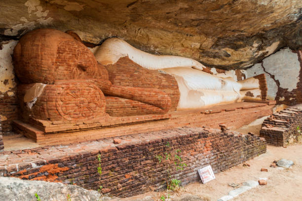 istock Statue of reclining Buddha under Pidurangala rock, Sri Lank 1313372094