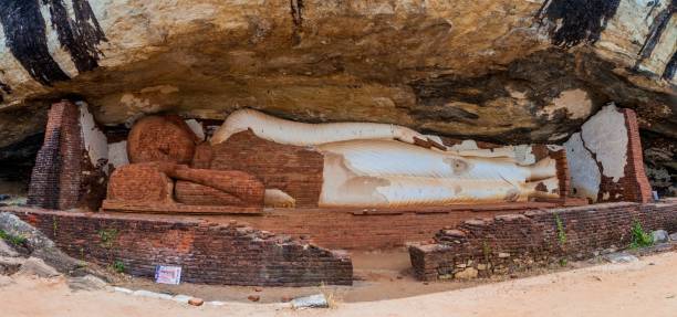 istock Statue of reclining Buddha under Pidurangala rock, Sri Lank 1313372137
