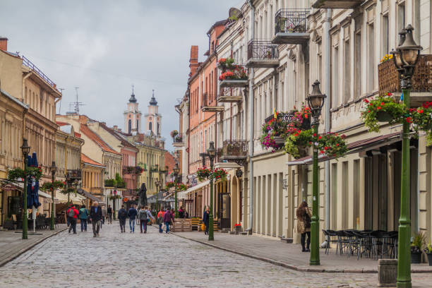 People walk along Vilniaus gatve street in Kaunas, Lithuani stock photo