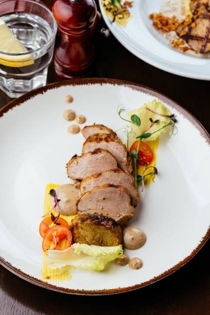istock grilled turkey fillet in a plate with vegetables, herbs and sauc 1313373612