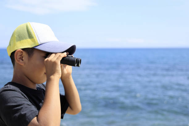 Japanese boy with opera glass at seaside (10 years old)