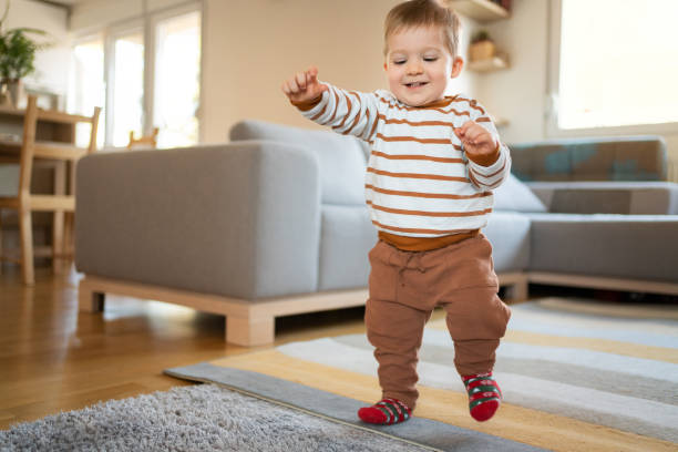 istock One cheerful little boy walking around the house 1313379383