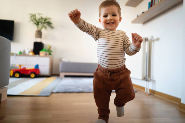 istock One smiling Caucasian toddler walking at home 1313379439