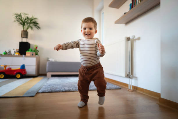 istock Smiling Caucasian toddler walking at home 1313379440