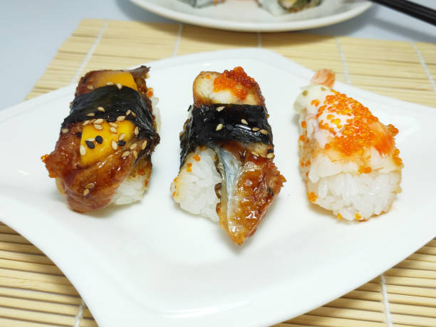 istock Three different flavors of sushi, salmon, fish roe, black sesame, close-up 1313388048