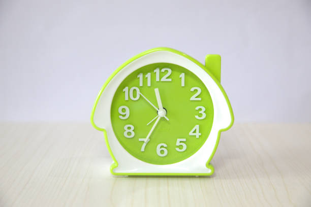 Small house-shaped alarm clock, green clock face dial and white frame, beautiful and cute