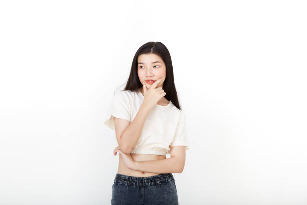 istock attractive Asian young woman thinking on over white background. 1313390375