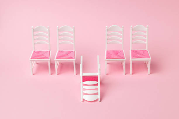 istock One fallen chair and four chairs standing in a row. 1313392323