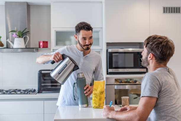 istock Young man writing in a paper while his boyfriend is preparing mate infusion 1313392441