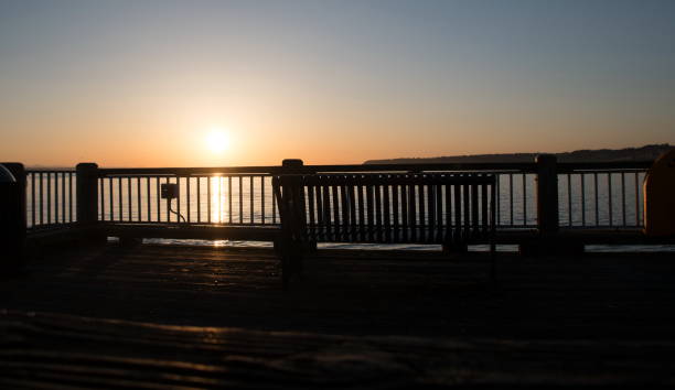 Silhouetted bench against orange sky with copy space around. Similar symbolic images: