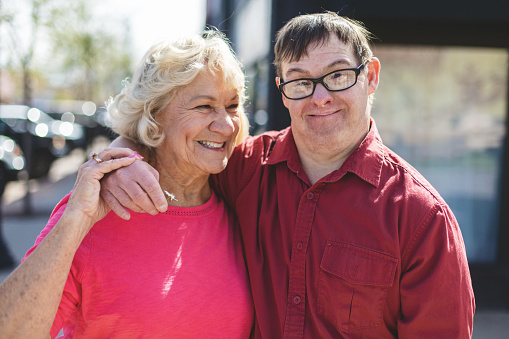 In Western Colorado Adult Man Portraits with a Down Syndrome Outdoors with Senior Female Guardian Photo Series Matching 4K Video Available (Shot with Canon 5DS 50.6mp photos professionally retouched - Lightroom / Photoshop - original size 5792 x 8688 downsampled as needed for clarity and select focus used for dramatic effect)