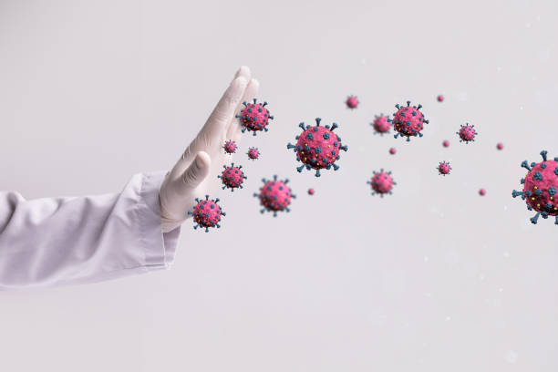 istock Doctor hand stopping covid-19 molecules 1313408056