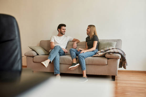 istock young couple sits on sofa and has a conversation 1313408337