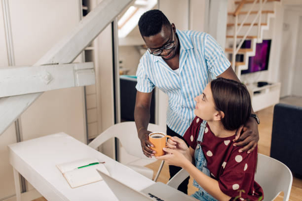 istock African American young man bringing coffee to his girlfriend while studying 1313409199