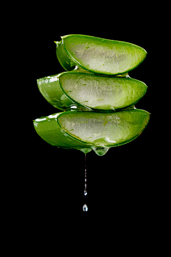 water or oil drop on aloe vera. beauty product concept.