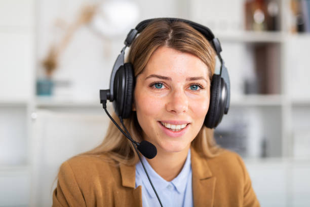 istock optimistic adult female operator sitting in white office 1313413583