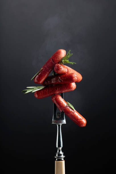 istock Small grilled sausages with rosemary. 1313414018