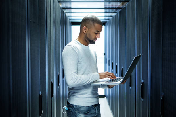 A black male server room technician working at business reopening