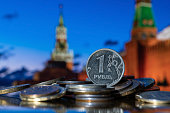 Coin in denomination of one Russian ruble against the background of the towers of the Moscow Kremlin