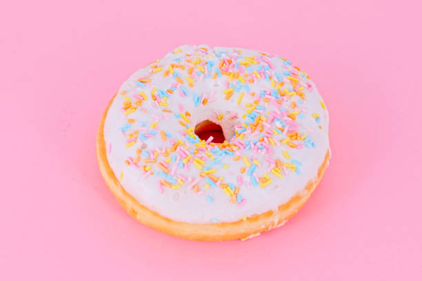 istock Fresh tasty colorful donuts isolated on lilac 1313416708