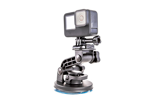 New 4K action camera on a suction mount in black color. Isolated on  white background
