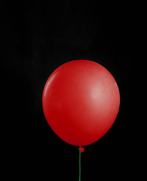 istock Beautiful red balloon on black isolated background. Layout 1313419127