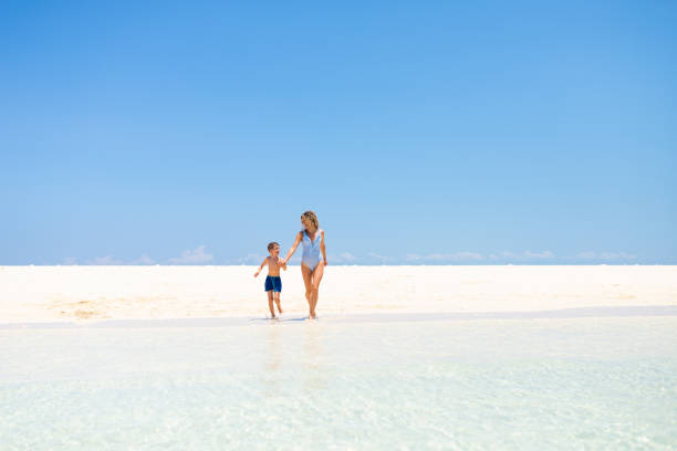 istock Happy mother and son running at the beach 1313419299