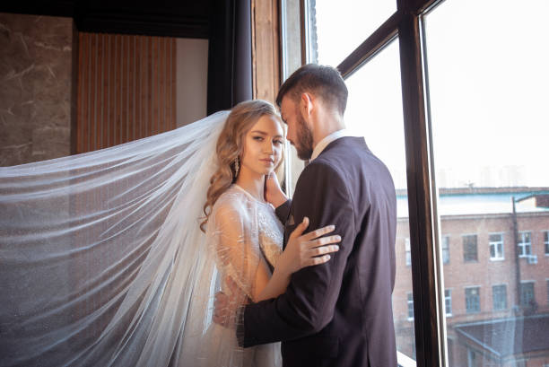 istock beautiful young couple. groom and bride. a modern wedding. dark interior 1313421945