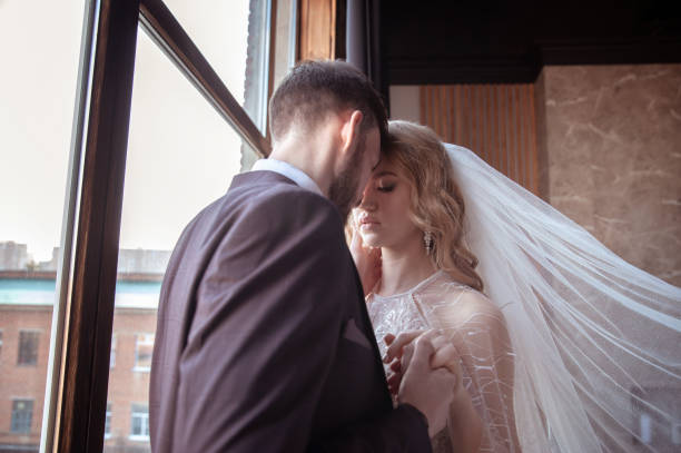 istock beautiful young couple. groom and bride. a modern wedding. dark interior 1313421969