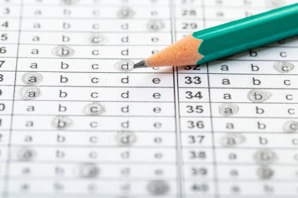 istock testing in exercise and exam paper. computer sheet with pencil in school test room, education concept 1313422652