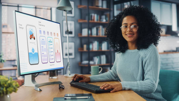istock Latina Female Specialist Working on Desktop Computer at Home Living Room while Sitting at a Table. Freelancer Developing New Food Delivery App Design, User interface in a Graphics Editing Software. 1313422680